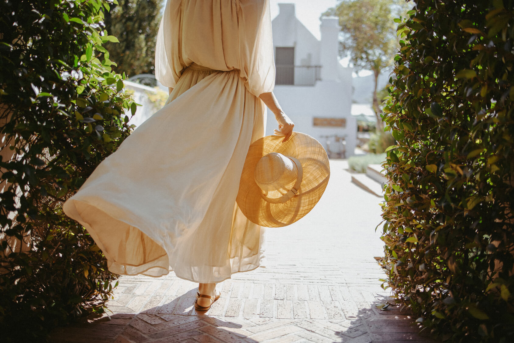 woman walking with hat in hand